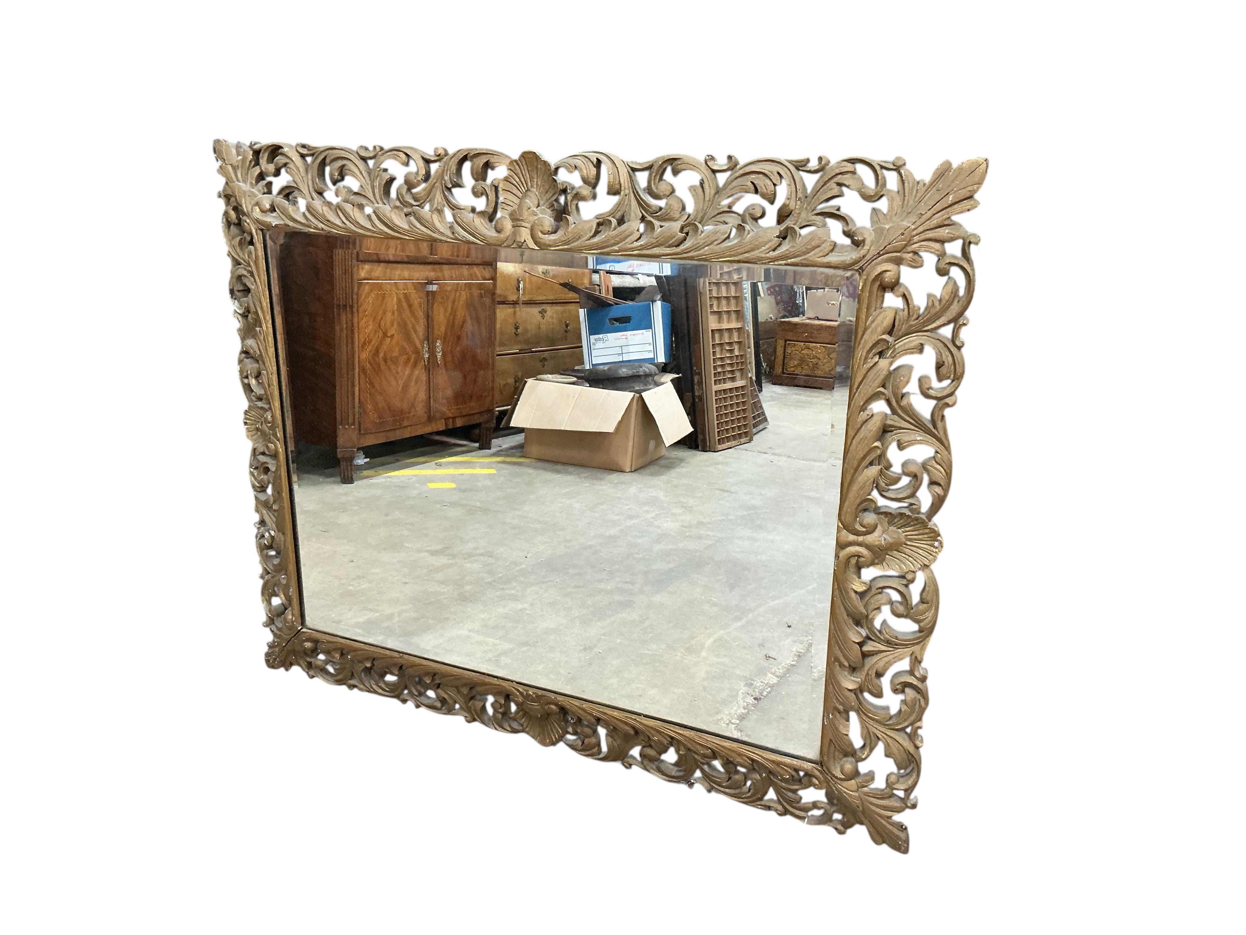 A large late 19th / early 20th century rectangular carved giltwood wall mirror, width 97cm, height 124cm